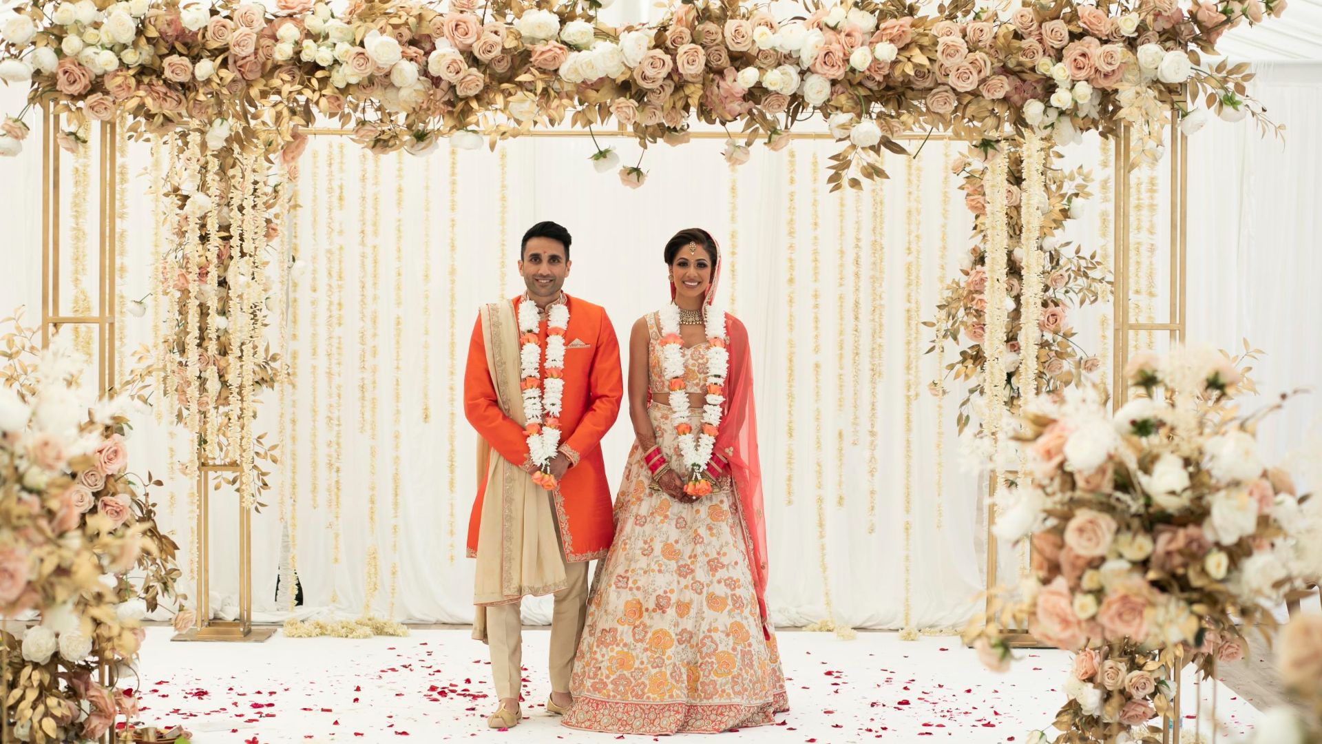An Asian bride and good standing under their décor. 