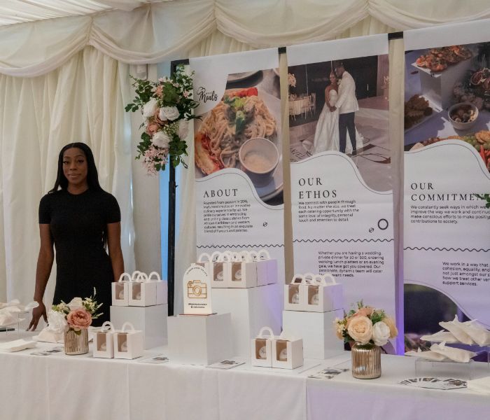 A caterer standing at her Showcase table. 