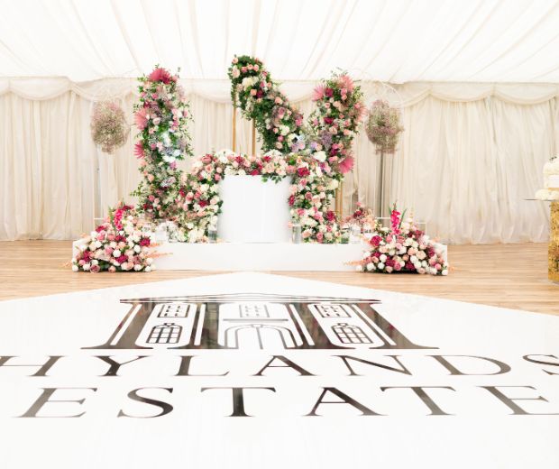Wedding table decorated with bright pink florals. 