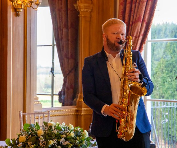 A man playing a saxophone. 