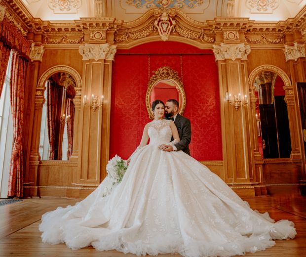 A groom holding his bride in the Banqueting Room. 