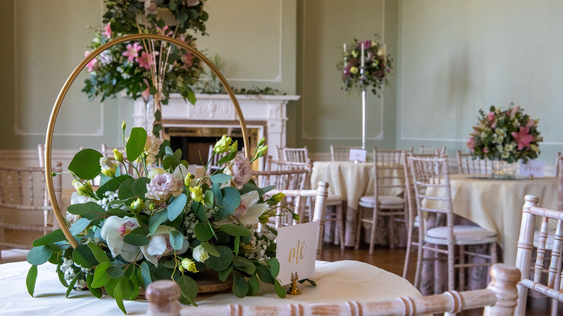 The Terrace Room decorated with pink florals and small round tables. 