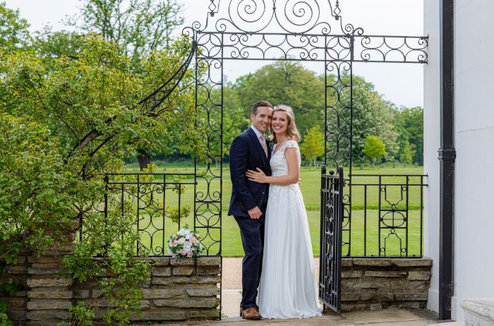 A bride and groom posing on the East Terrace. 