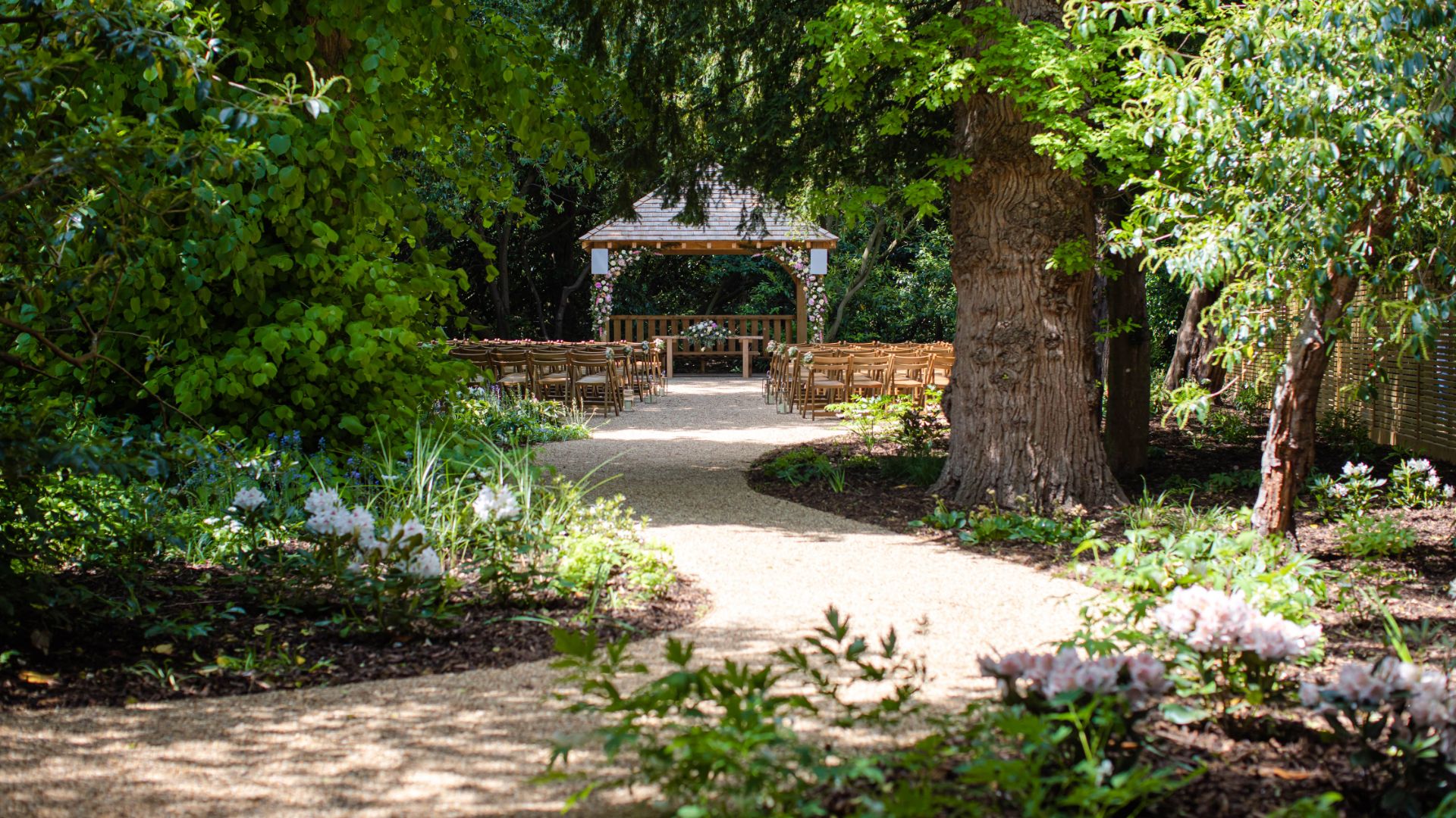 The outdoor ceremony garden surrounded by trees. 