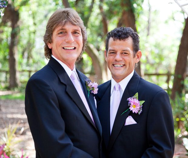 Two men wearing boutonnieres.