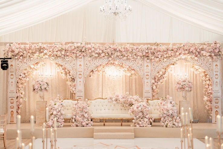 The Grand Pavilion decorated with white and light pink flowers. 