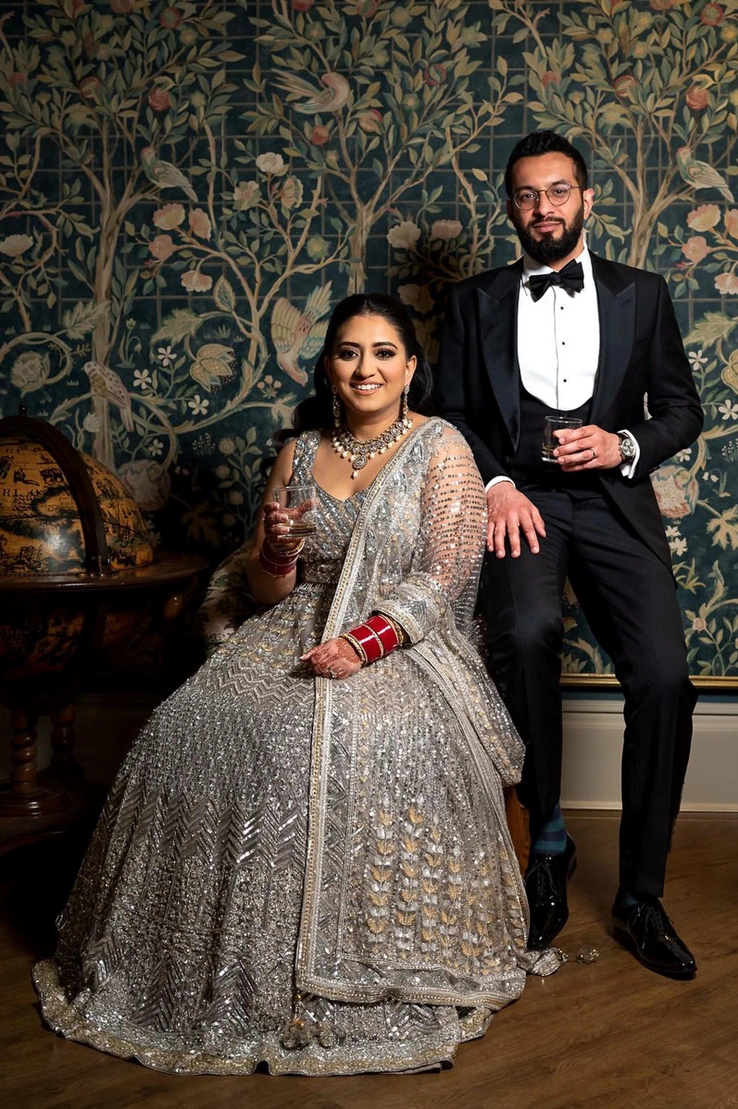 A couple posing in front of the accent wall of the Repton Room. 
