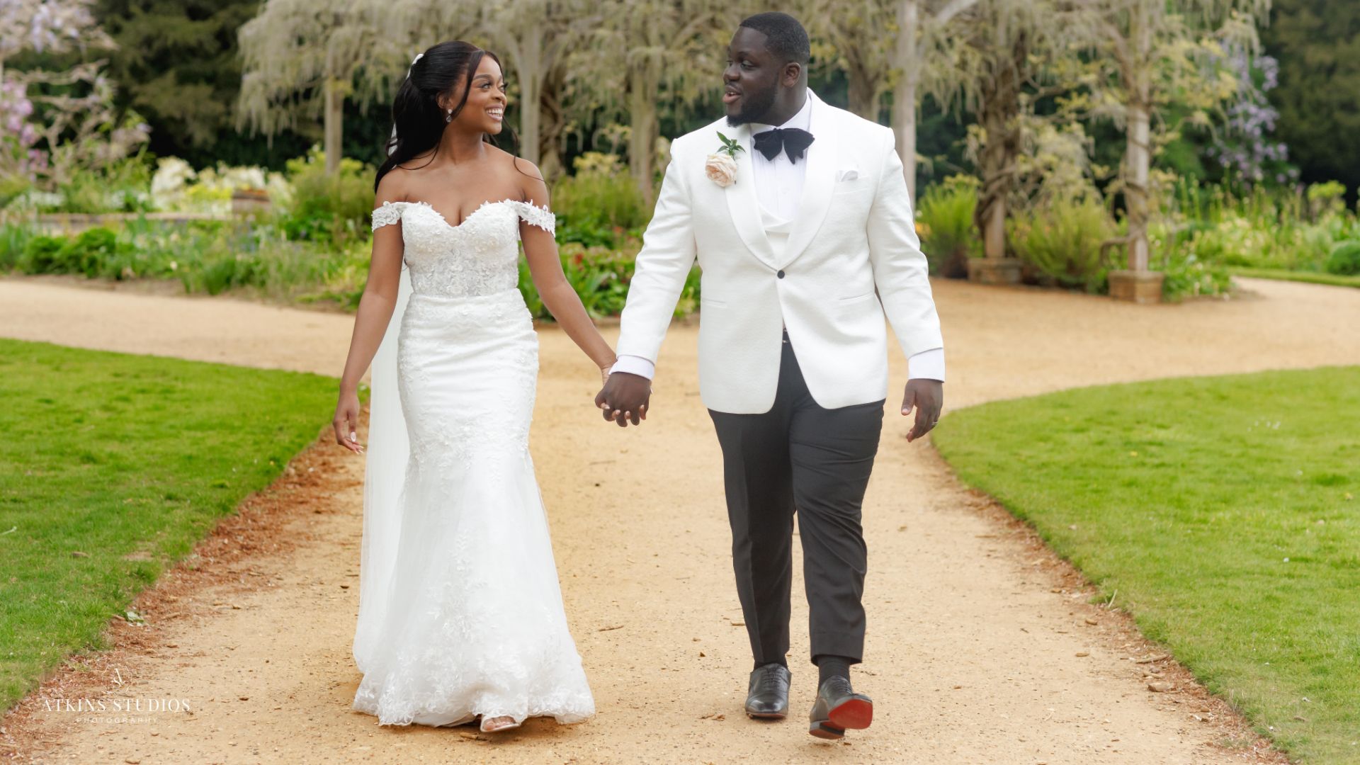 A couple walking hand-in-hand in the Pleasure Gardens. 