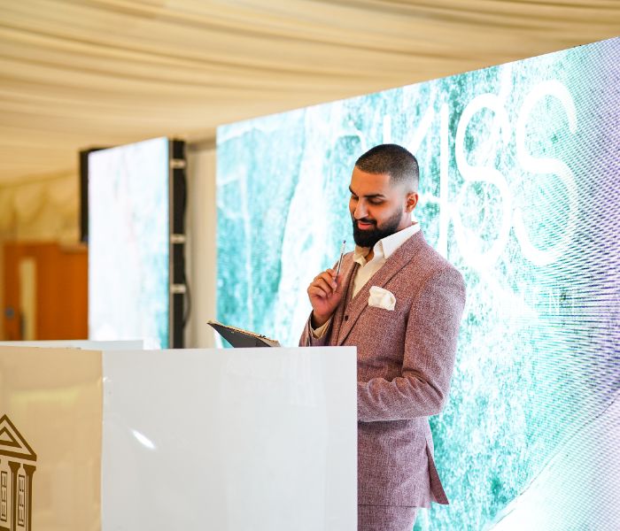 A DJ standing behind his booth. 