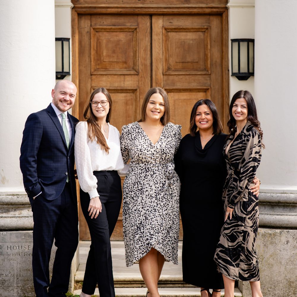 The Hylands Estate Events & Weddings Team smiling outside the front entrance of Hylands House. 