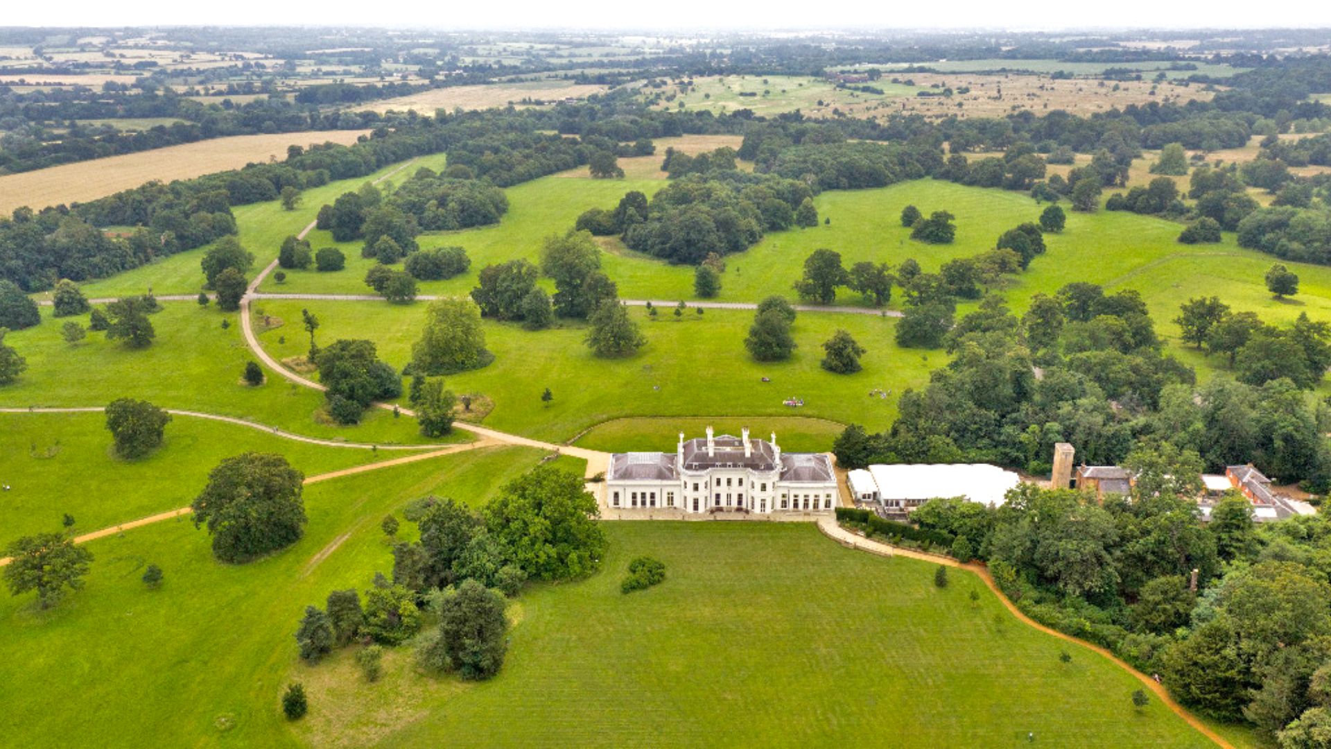 An aerial photo of Hylands House and its surrounding green parkland. 