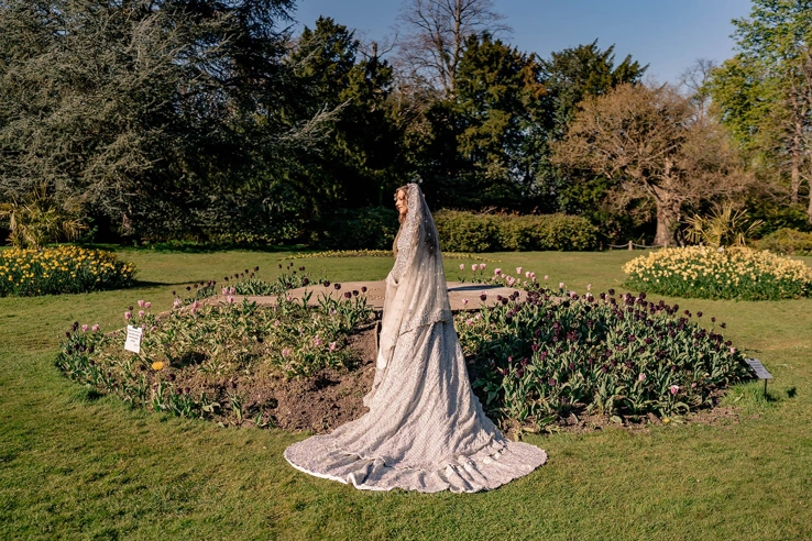 A bride standing by the tulips in the Pleasure Gardens. 